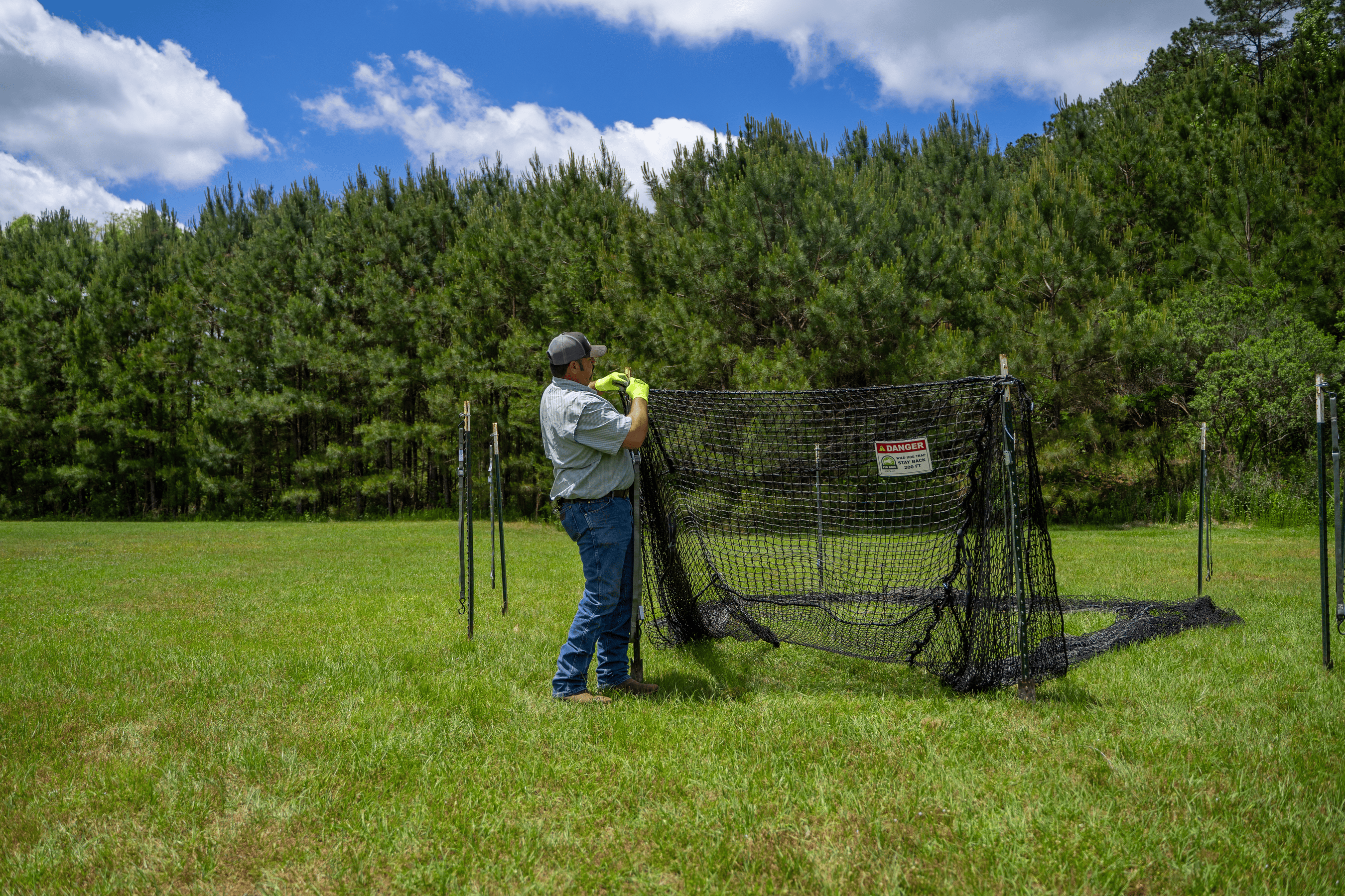 Man setting or taking down Pig Brig wild boar trap system