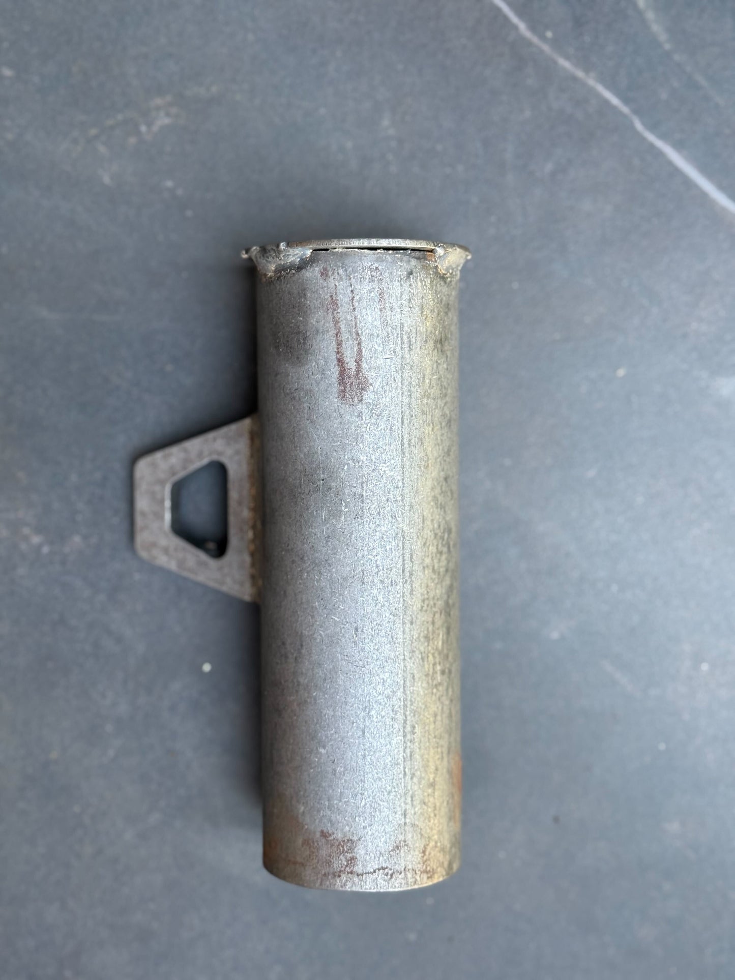 Metal exhaust pipe on a gray surface