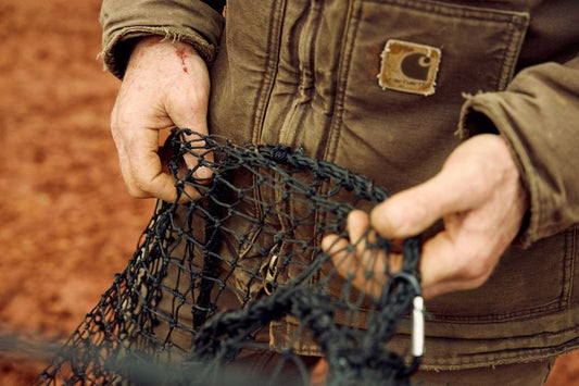 Man repairing Pig Brig net