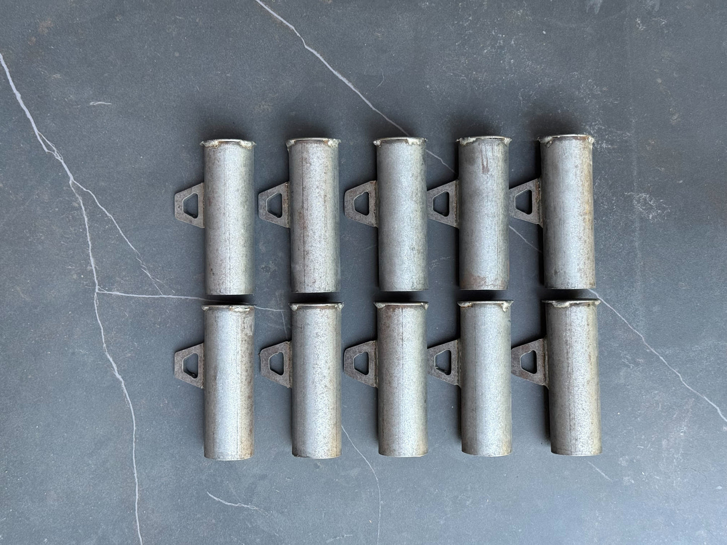 Set of metal brackets on a gray surface