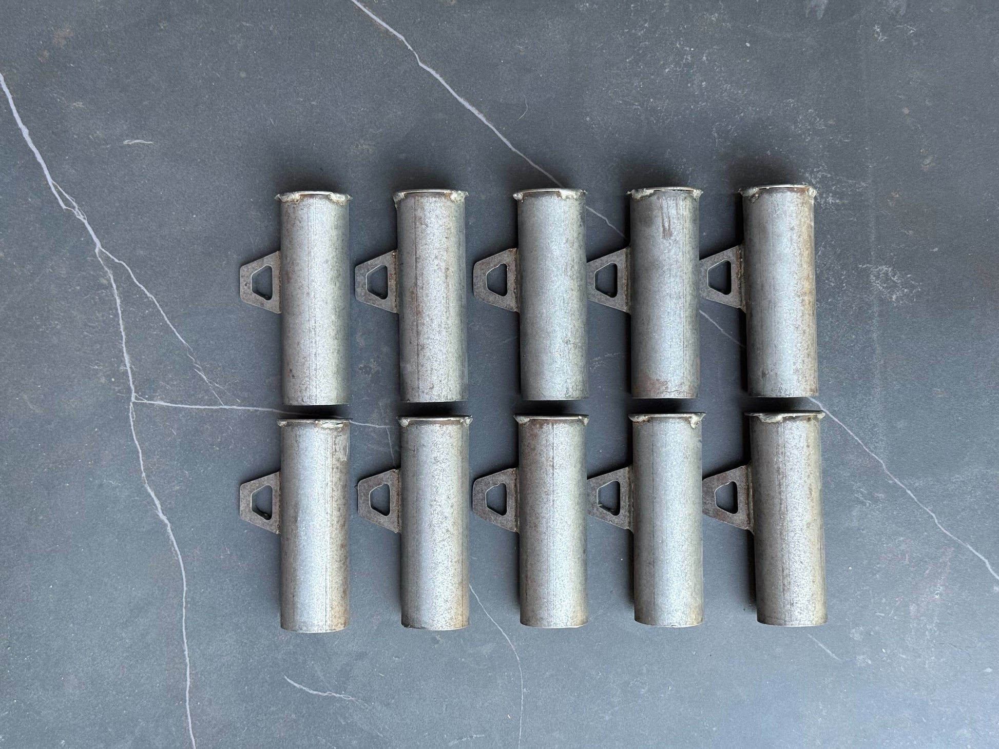 Set of metal brackets on a gray surface