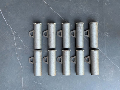 Set of metal brackets on a gray surface